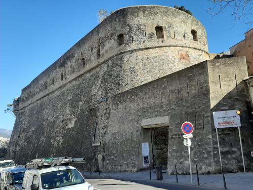 a large building with a tower on the side of it at Ribellu in Bastia