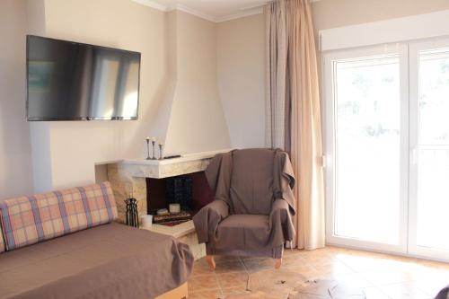 a living room with a chair and a fireplace at Apartment Achilles in Litochoro
