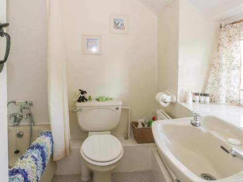 a white bathroom with a toilet and a sink at 31 Outgang Road in Pickering