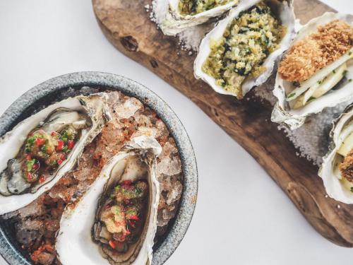 a plate of oysters on a cutting board at The Royal Yacht in Saint Helier Jersey