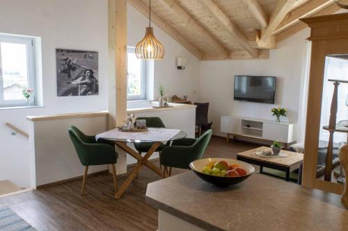 a kitchen and living room with a table and chairs at Bergkiefer - Ferienwohnung in Oy-Mittelberg