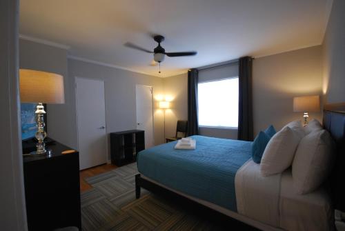 a hotel room with a bed and a window at Brookwood Courtyard by BCA Furnished Apartments in Atlanta