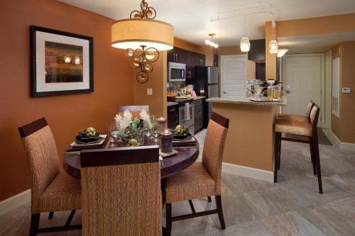 a kitchen and dining room with a table and chairs at Holiday Inn Club Vacations at Desert Club Resort in Las Vegas
