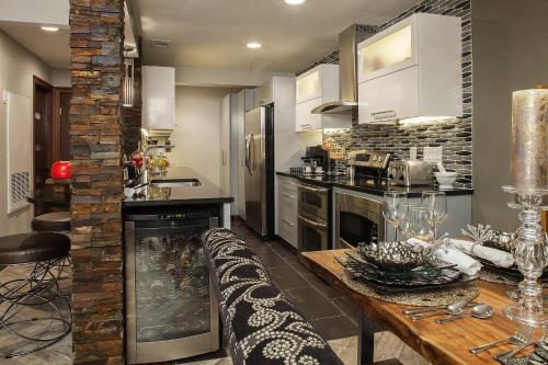 a kitchen with a wooden table and a counter at Holiday Inn Club Vacations at Desert Club Resort in Las Vegas