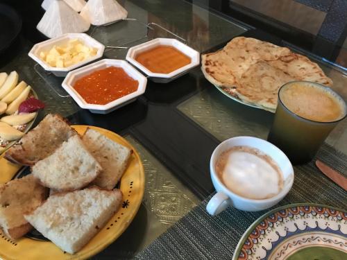 a table with a plate of bread and a cup of coffee at Villa #1 ‘Rosalie’ in Marrakech