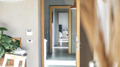 a hallway with a door leading to a room at Agriresort Villa Gelso- Adults Friendly in Vesime