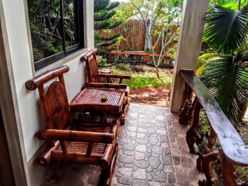 two chairs sitting on the porch of a house at Adayo Cove Resort in Siquijor