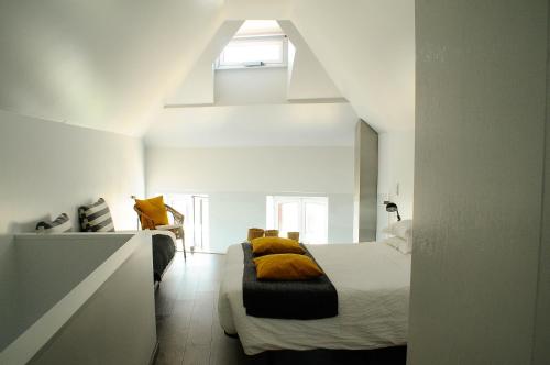 een slaapkamer met een bed met gele kussens erop bij Aveiro Rossio Apartments in Aveiro
