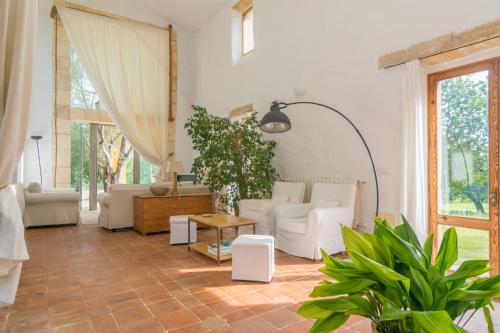 a living room with white furniture and a large window at Viterbo in Son Servera
