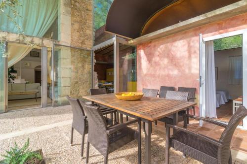 a wooden table and chairs on a patio at Viterbo in Son Servera