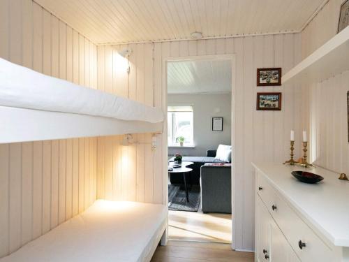 a room with a bunk bed and a living room at Holiday home Assens VI in Assens
