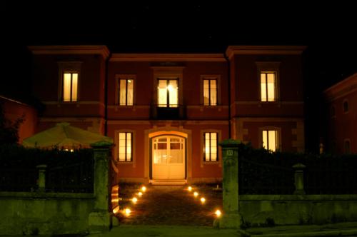 a house with a white door at night at B&B Villa al Lago in Farra dʼAlpago
