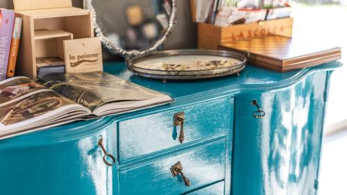 a blue dresser with a book on top at Agriresort Villa Gelso- Adults Friendly in Vesime
