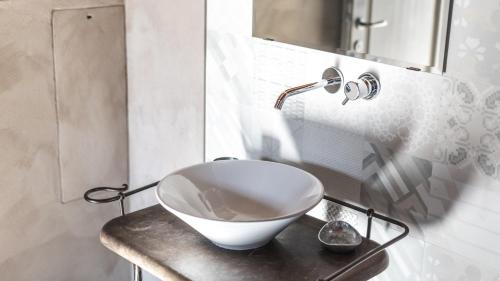 a white bowl on a counter in a bathroom at Agriresort Villa Gelso- Adults Friendly in Vesime