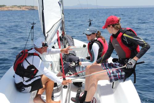 a group of people on a sailboat in the water at Calanova Sports Residence in Palma de Mallorca