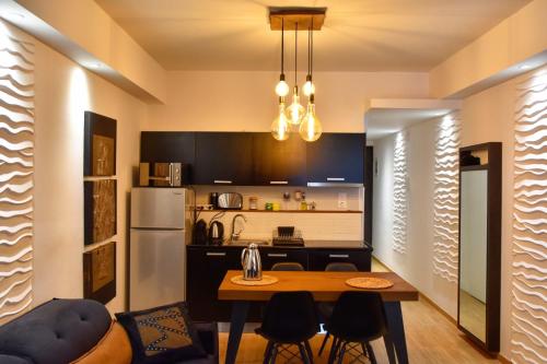 a kitchen with a table and a refrigerator at Lycabettus Exclusive Apartments in Athens