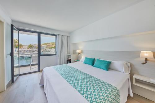 a bedroom with a bed with a view of the water at Calanova Sports Residence in Palma de Mallorca