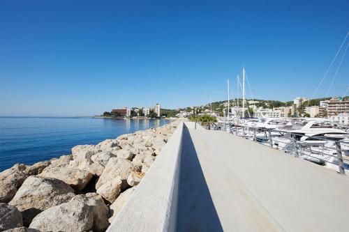 a dock with a bunch of boats in the water at Calanova Sports Residence in Palma de Mallorca
