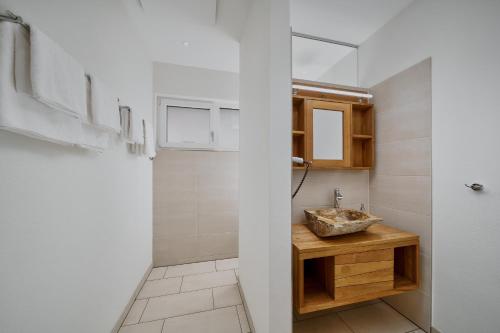 a bathroom with a sink and a mirror at Villa Salzburg by Welcome to Salzburg in Salzburg