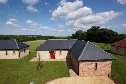 an aerial view of a barn with a red door at Barrow Hill Barns in Petersfield