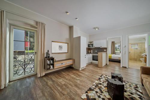 a living room with a couch and a kitchen at Villa Salzburg by Welcome to Salzburg in Salzburg