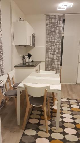 a kitchen with a table and chairs in a room at Ferienwohnung Villa Josephine in Badenweiler