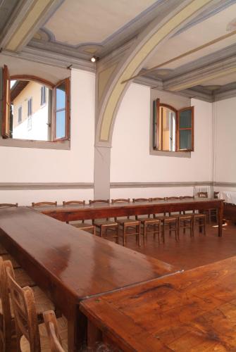 an empty room with wooden tables and chairs at Villa Morghen in Settignano
