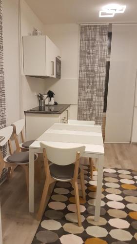 a kitchen with a table and chairs in a room at Ferienwohnung Villa Josephine in Badenweiler