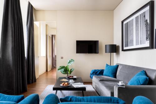 a living room with a couch and a table at JOIVY Downtown Market Apartments in Lisbon