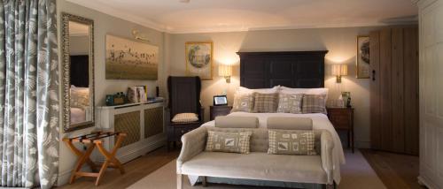 a bedroom with a large bed and a chair at Luxury Escape in Hunstanton