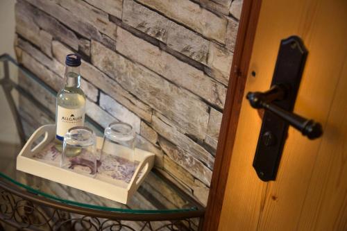 a bottle of wine on a cart with glasses at Landgasthof Zum Alten Reichenbach in Nesselwang