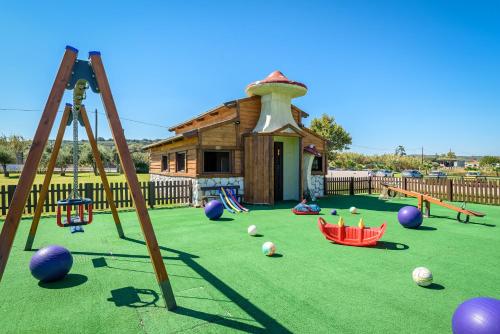 a play area with a playground with a building at Solimar Aquamarine Resort in Gerani Chanion