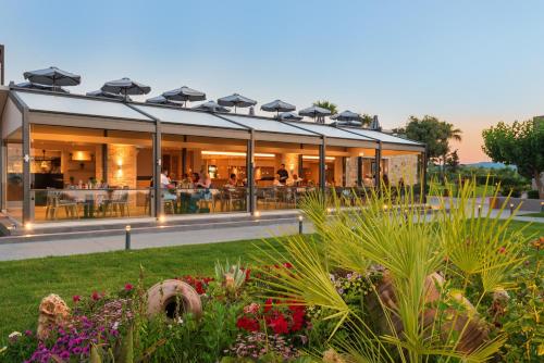 a building with a garden in front of it at Solimar Aquamarine Resort in Gerani Chanion