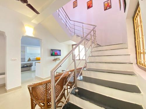 a staircase in a home with a purple ceiling at Le Royce Villa - TIE Hotels & Resorts in Puducherry