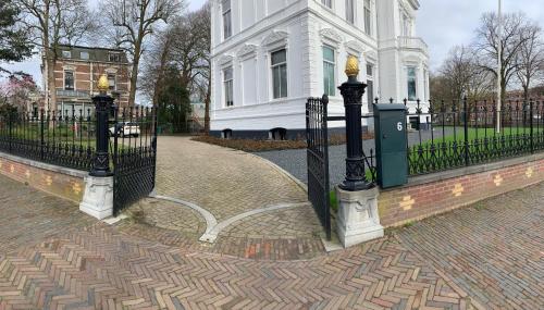 a black wrought iron fence in front of a white building at B&B Florapark in Haarlem