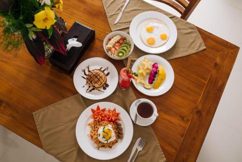 a table with plates of breakfast food on it at The Sidemen Villa in Sidemen