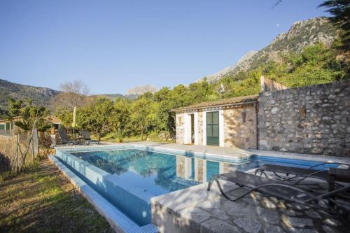 a villa with a swimming pool and a house at Es Tarongers in Sóller