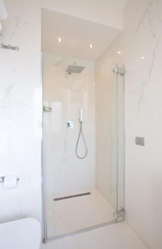 a shower with a glass door in a bathroom at Suite Milano Duomo in Milan
