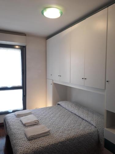 Ένα ή περισσότερα κρεβάτια σε δωμάτιο στο Le Torri Apartments