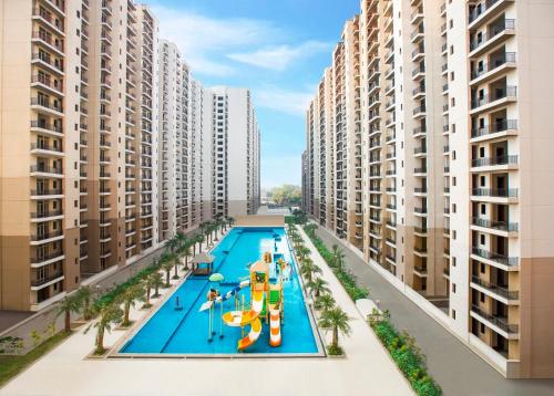 an aerial view of a swimming pool in a apartment complex at Downtown Delight in Lucknow