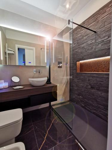 a bathroom with a sink and a glass shower at Vomero Guest House in Naples