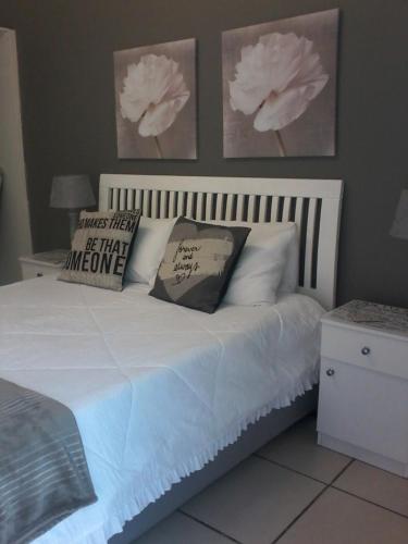 a bed with pillows on it in a bedroom at Tehillah Guesthouse in Upington