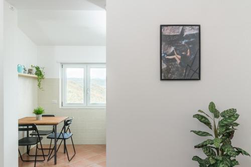 a kitchen and dining room with a table and chairs at Casa Elisabetta ShortLets in Caposele