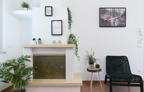 a living room with a fireplace and a chair at Casa Elisabetta ShortLets in Caposele