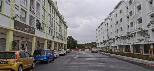 a street with cars parked on the sides of buildings at UNIE HOMESTAY in Wakaf Che Yeh