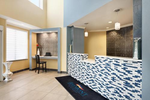 a bathroom with a blue and white tile counter at Baymont by Wyndham Ft. Leonard/Saint Robert in Saint Robert