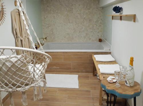 a room with a hammock and a table and a tub at La Mar de Ben in Muros