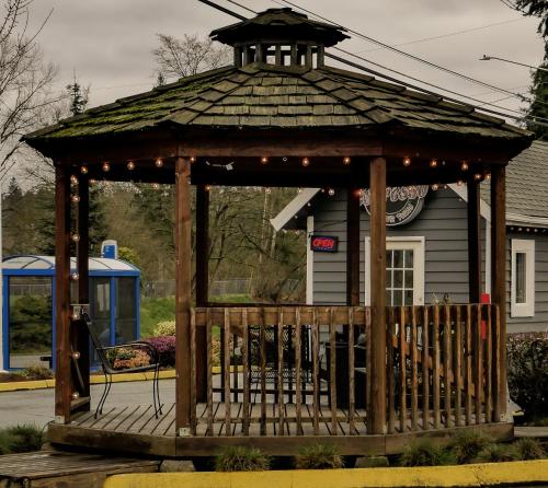 a wooden gazebo in front of a house at Snohomish Inn in Snohomish