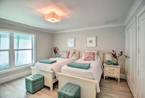 two twin beds in a room with a window at Lavish Vero Beach Escape with Pool, Patio and Dock! in Vero Beach