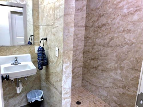 a bathroom with a sink and a shower at SLC Hostel in Salt Lake City